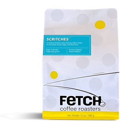 Scritches has a turquoise label offset to the left and toward the top of the white reclosable coffee bag. The bottom of the bag has a yellow band, and the logo shows a bean sitting at the base of the 'h' in the word Fetch.